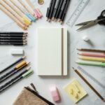 Home 87 Back to school supplies list flat lay showing notebooks gel pens colored pencils highlighters ruler and stationery on white marble
