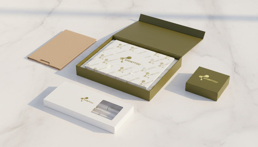 Custom stationery packaging options showing rigid gift box kraft slipcase window carton and folding carton with foil stamping on white marble