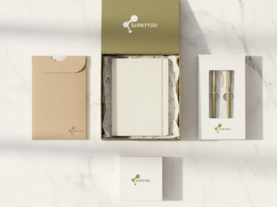 Custom stationery packaging options showing rigid gift box kraft slipcase window carton and folding carton with foil stamping on white marble