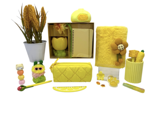Yellow stationery and gift accessories arranged as a coordinated product range.